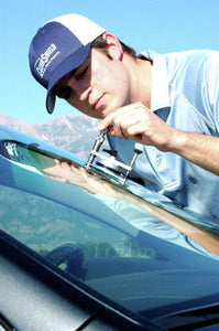 male technician repairing a windshield